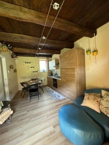 a living room with a blue couch and a table at Luna Home in Arona
