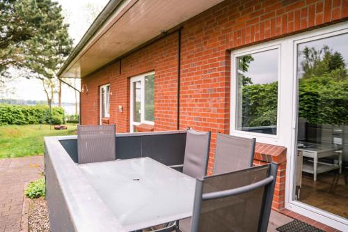 a white table and chairs on a patio at Appartementhaus Schleiblick in Kappeln