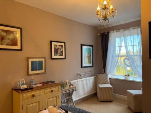 a childs bedroom with a chandelier and a window at Simonburn Bed and Breakfast 