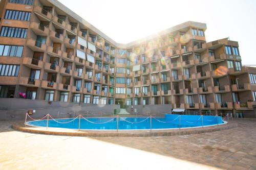 a building with a blue fence in front of it at Teulada cozy flat with pool and beach access in Teulada