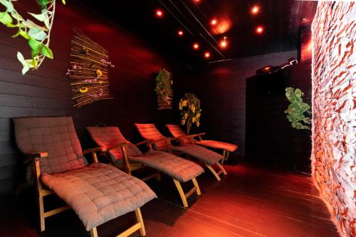 a row of chairs in a dark room with lights at La Roche-en-Ardenne, La Rive 4P or La Forêt 17P in Mellet