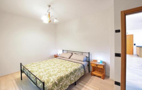 a bedroom with a bed and a night stand at 2 Bedroom Cozy Apartment In Lamon in Lamon