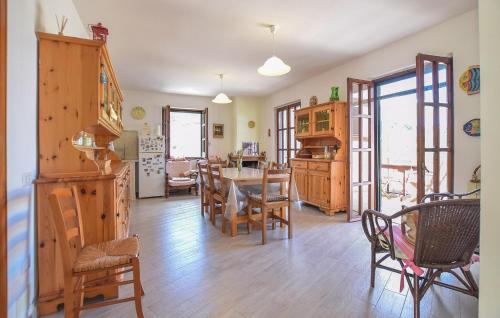a kitchen and dining room with a table and chairs at Nice Home In Perdifumo in Perdifumo