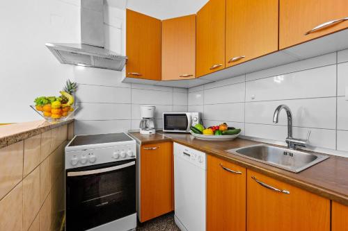 a kitchen with a sink and a stove top oven at Holiday Home Mario in Pula