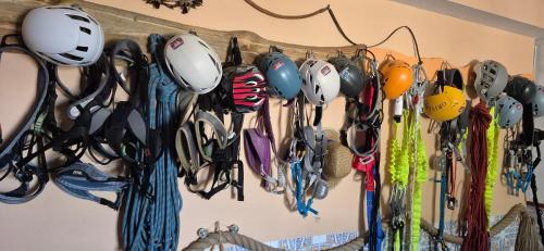 a bunch of helmets hanging on a wall at Casa do Monte in Castro Daire