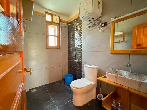 un baño con inodoro y lavabo en Bens Villa, en Haripūr