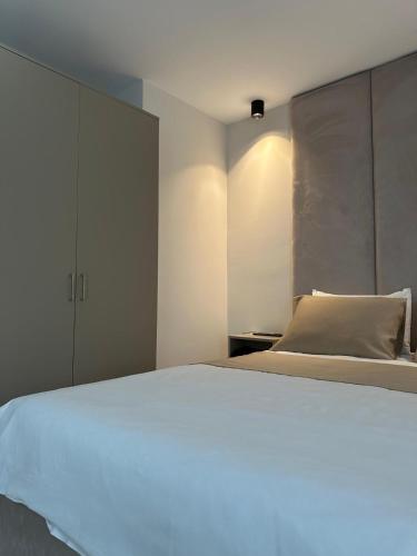 a bedroom with a large white bed and a cabinet at THE DECK OTEL in Trabzon