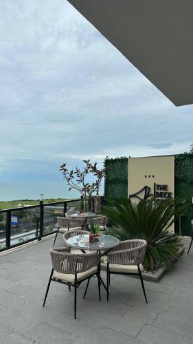 a patio with a table and chairs on a balcony at THE DECK OTEL in Trabzon
