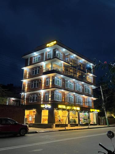 a lit up building on a city street at night at Hotel Bharosa Inn in Kathmandu
