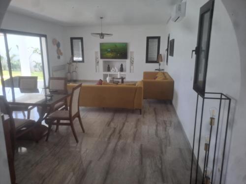 a living room with a couch and a table at Villa julia in Hammamet