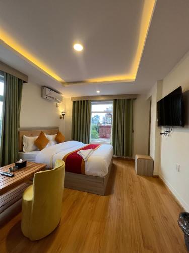 a hotel room with a bed and a desk at Hotel Bharosa Inn in Kathmandu