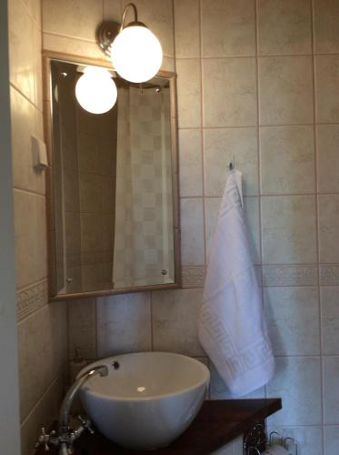 a bathroom with a sink and a mirror at Tiittalan Kartano in Sulkava