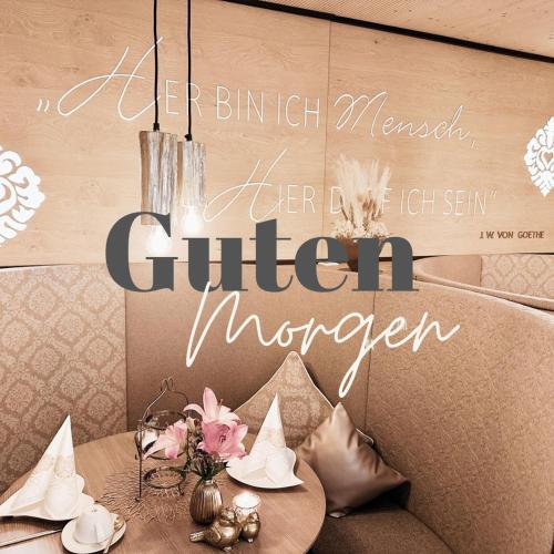 a sign for a dining table in a restaurant at Fichtenwald-Ihr Boutique I Glück`s Hotel in Bad Füssing
