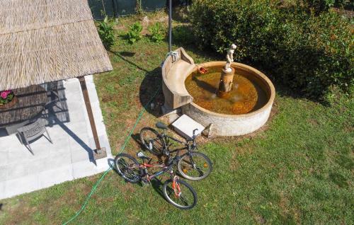 a bicycle is parked next to a fountain at Cozy Home In Montefiascone in Montefiascone