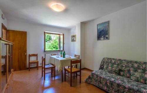 a living room with a table and a couch at Cozy Apartment In Montemonaco in Montemonaco