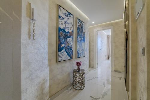 a hallway with paintings on the wall and a vase on the floor at Poolside Escape - airco & heated pool in Adeje
