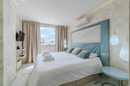 a bedroom with a large bed and a window at Poolside Escape - airco & heated pool in Adeje