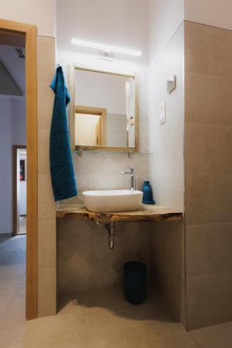 a bathroom with a sink and a mirror at Bambi Boutique Rooms - Loftové izby 300 m od centra Banskej Bystrice, Self check-in in Banská Bystrica