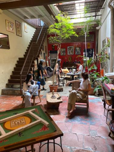 a group of people sitting in a room with stairs at Bitterswiit Ladies Hostel in George Town