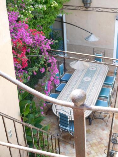 a balcony with a table and chairs and flowers at Palais Oumensour in Taroudant