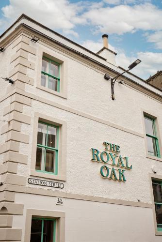 a white building with a royal oak sign on it at Royal Oak at Keswick in Keswick