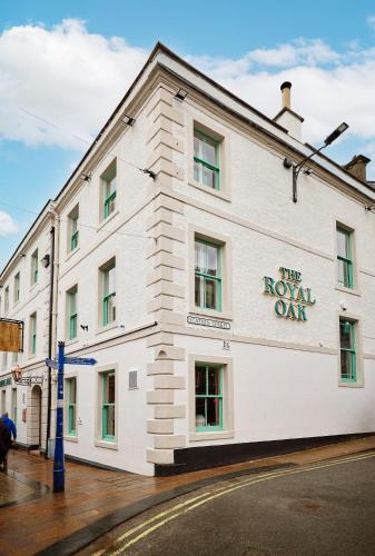 a white building with the novel oak sign on it at Royal Oak at Keswick in Keswick