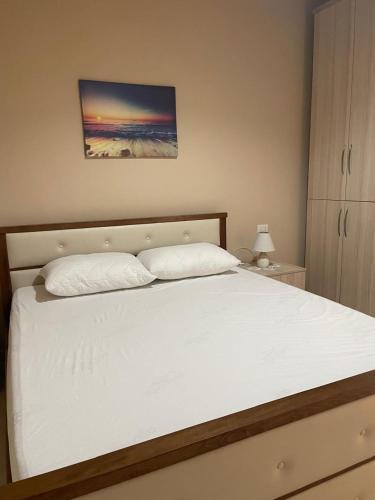 a bed with two pillows on it in a bedroom at Lindita Vila Vlora in Vlorë