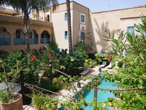 a garden with a swimming pool in a building at Palais Oumensour in Taroudant