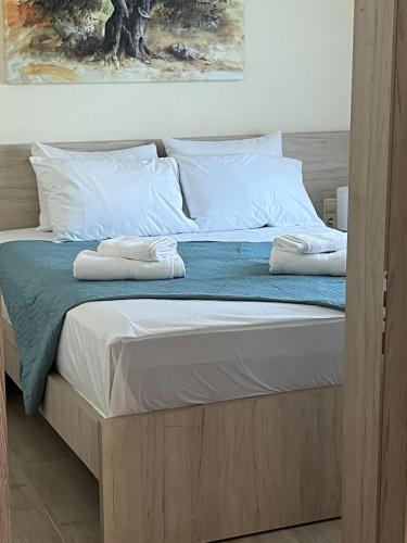 a bed with two towels on top of it at Two little olives Studio apartment in Kissamos