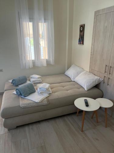 a large couch in a room with a table at Two little olives Studio apartment in Kissamos