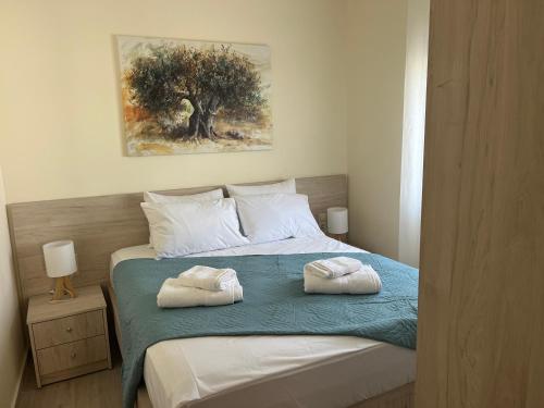 a bedroom with two towels on a bed at Two little olives Studio apartment in Kissamos
