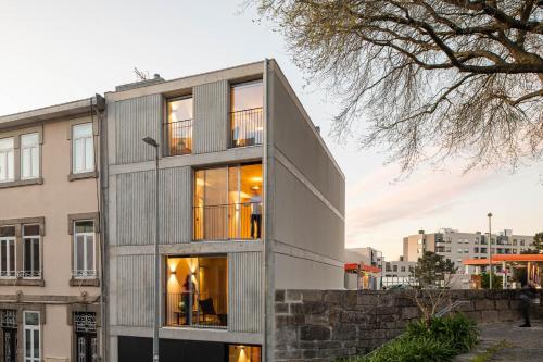 a timber house with large windows at Coelho 145 in Porto