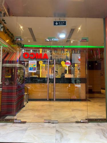 a glass door of a store with a sign on it at Akasiya Hotel - Formerly known as Fal Hotel in Dubai