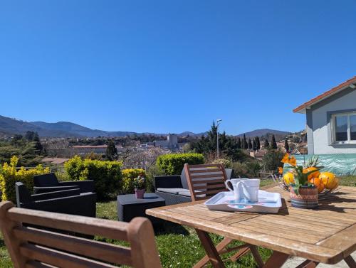 a table and chairs on a patio with a view at Le Jardin Secret, Vue sur le château & Parking in Foix