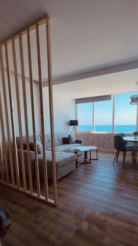 a living room with a bed and a couch and some windows at Sky&Beach Apartments in Aguadulce