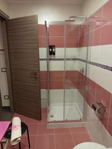 a bathroom with a shower with pink and white tiles at B&B Lido Esperando in Sciacca