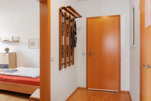 a door to a bedroom with a bed in a room at Ferienwohnung Jacobi Kurfürst in Naumburg