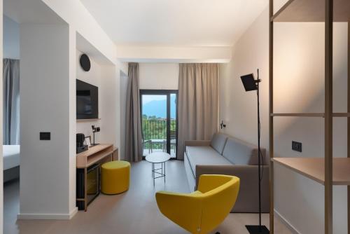 a living room with a couch and a table at Hotel Royal Village in Limone sul Garda