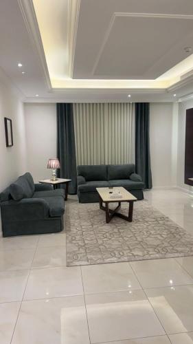 a living room with two couches and a coffee table at East Diamond Serviced Apartments in Jeddah