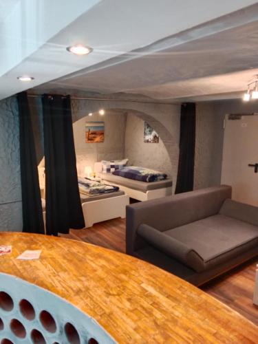 a living room with two beds and a table at Glücksburg Strandnah an der Förde in Glücksburg