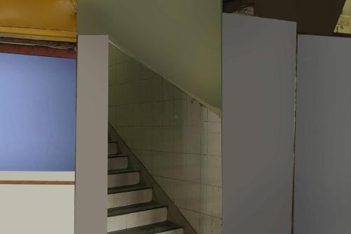a staircase in a room with a wall and a stair case at Hotel O New Om Palace in Bhopal