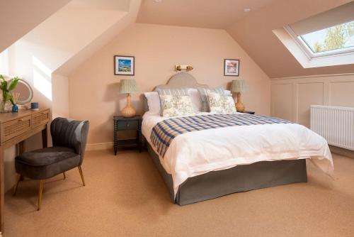 a bedroom with a bed and a desk and a chair at Windy Cottage, Coldstream in Coldstream