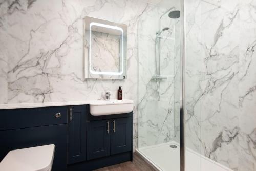 a bathroom with a sink and a shower at Windy Cottage, Coldstream in Coldstream