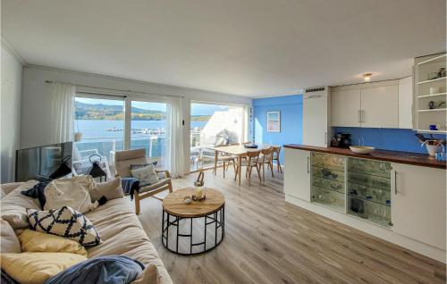 a living room with a couch and a table at Beautiful Apartment In Uggdal With House Sea View in Uggdal