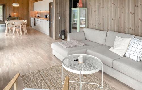 a living room with a couch and a table at 3 Bedroom Amazing Home In Åfarnes in Åfarnes
