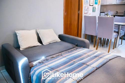a blue bed in a room with a table at Tambaú Flex Home - LikeHome in Tambaú