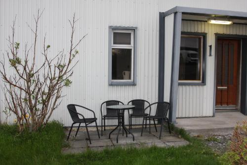 a table and chairs in front of a house at The Castle in Búðardalur