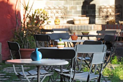a group of tables and chairs with vases on them at Hotel Lucrezia in Riola Sardo