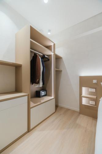a walk in closet with white walls and wooden shelves at Maison Sirolo in Sirolo