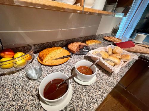 a counter top with two cups of tea and bread at Agritur Anselmi in Terzolas